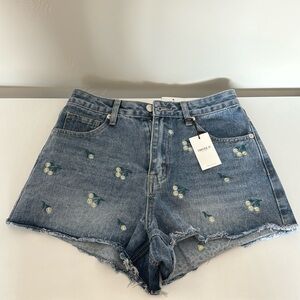 blue jean shorts with embroidered white daisies